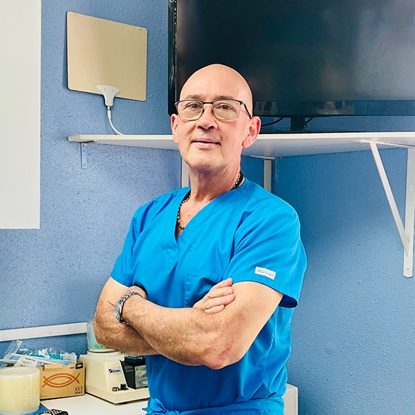 Dentist Juan Carlos Barbosa Posing In Blue Scrubs